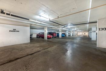 A parking garage with a "NO PARKING" sign on the wall.